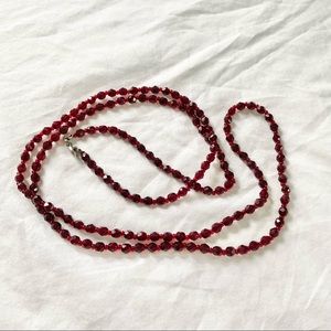 Long red beaded necklace